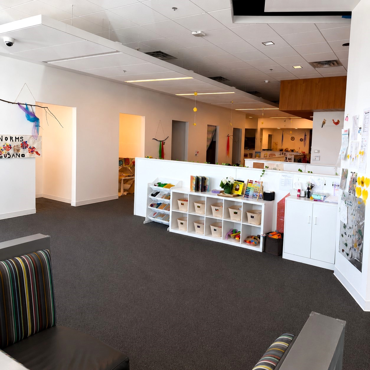 Bright, organized classroom at Edina Daycare with open shelving, labeled supplies, and child-centered learning areas, supporting independence, exploration, and collaborative learning.